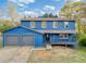 Charming blue split-level home featuring an attached garage and covered front porch at 2224 Bridle Ct, Norcross, GA 30071