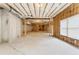 Unfinished basement showcasing concrete floor, natural light, wooden frame walls, and exposed insulation at 3284 Kylee Dawn Cir, Lawrenceville, GA 30045
