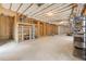 Unfinished basement with concrete floor, wooden frame walls, overhead insulation, and a shelf at 3284 Kylee Dawn Cir, Lawrenceville, GA 30045