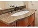 Bathroom vanity with a granite countertop, sink, faucet, and wood cabinet at 3284 Kylee Dawn Cir, Lawrenceville, GA 30045
