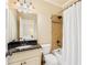 Bathroom with vanity featuring black granite countertop and a tub-shower with tiled walls at 3284 Kylee Dawn Cir, Lawrenceville, GA 30045