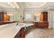 Elegant bathroom boasts a soaking tub, dual sinks, and a large window with decorative glass at 3284 Kylee Dawn Cir, Lawrenceville, GA 30045