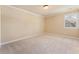 Spacious bedroom showcasing neutral walls, plush carpet, and a window for natural lighting at 3284 Kylee Dawn Cir, Lawrenceville, GA 30045