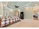 Large primary bedroom suite boasts tray ceiling and view to the bath with soaking tub at 3284 Kylee Dawn Cir, Lawrenceville, GA 30045