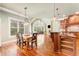 Open concept dining room with hardwood floors, fireplace, and large windows for natural light at 3284 Kylee Dawn Cir, Lawrenceville, GA 30045