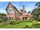 Elegant two-story brick home with a well-manicured lawn, mature landscaping, and a charming outdoor deck at 3284 Kylee Dawn Cir, Lawrenceville, GA 30045