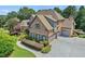 Beautiful brick home featuring a 3-car garage, lush landscaping and a private backyard with mature trees at 3284 Kylee Dawn Cir, Lawrenceville, GA 30045