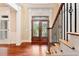 Elegant foyer with hardwood floors, a decorative glass front door and staircase with wrought iron spindles at 3284 Kylee Dawn Cir, Lawrenceville, GA 30045