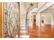 Grand foyer with hardwood floors, a staircase with iron railings and a view of the living room with a fireplace at 3284 Kylee Dawn Cir, Lawrenceville, GA 30045