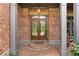 Elegant brick entryway featuring double doors with decorative glass and stately columns, creating a grand entrance at 3284 Kylee Dawn Cir, Lawrenceville, GA 30045