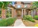 Charming brick home with a covered front porch, a beautifully landscaped front yard and a glass front door at 3284 Kylee Dawn Cir, Lawrenceville, GA 30045