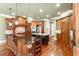 Spacious kitchen with rich wood cabinetry, granite counters, hardwood floors, and modern stainless-steel appliances at 3284 Kylee Dawn Cir, Lawrenceville, GA 30045