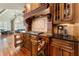 A great kitchen has custom wood cabinets, granite countertops, decorative tile backsplash, and gas range at 3284 Kylee Dawn Cir, Lawrenceville, GA 30045
