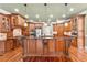 Spacious kitchen featuring granite counters, custom cabinetry, stainless steel appliances, and hardwood floors at 3284 Kylee Dawn Cir, Lawrenceville, GA 30045