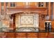Close up of the kitchen with custom wood cabinets, granite countertops, decorative tile backsplash, and gas range at 3284 Kylee Dawn Cir, Lawrenceville, GA 30045
