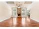 Bright living room featuring hardwood floors, stone fireplace, arched windows, and a view to another room at 3284 Kylee Dawn Cir, Lawrenceville, GA 30045
