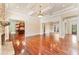 Open living room with hardwood floors, coffered ceiling, stone fireplace, and view to the kitchen at 3284 Kylee Dawn Cir, Lawrenceville, GA 30045