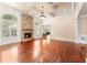 Elegant living room with hardwood floors, coffered ceilings, and a stone fireplace with arched windows at 3284 Kylee Dawn Cir, Lawrenceville, GA 30045