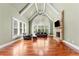 Bright living room with vaulted ceilings, hardwood floors, fireplace, and large windows with plantation shutters at 3284 Kylee Dawn Cir, Lawrenceville, GA 30045
