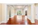 Spacious living room with hardwood floors, crown molding, and large windows offering plenty of natural light at 3284 Kylee Dawn Cir, Lawrenceville, GA 30045