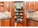 A pantry provides plenty of storage space for groceries and kitchen essentials with custom wood cabinets at 3284 Kylee Dawn Cir, Lawrenceville, GA 30045