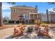 Spacious backyard boasting an outdoor seating area with fire pit and covered porch at 3640 Ridgeway Ter, Suwanee, GA 30024
