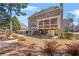 View of the backyard with patio, fire pit, screened porch, and stairs to the yard at 3640 Ridgeway Ter, Suwanee, GA 30024