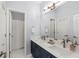 Modern bathroom featuring double sinks, navy cabinets, and bright natural light at 3640 Ridgeway Ter, Suwanee, GA 30024