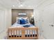 Cozy bedroom with blue accents, wood bed frame, and ample closet space offering comfort and functionality at 3640 Ridgeway Ter, Suwanee, GA 30024