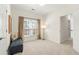 Inviting bedroom with a seating bench, window with natural light, and simple décor at 3640 Ridgeway Ter, Suwanee, GA 30024