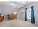 Charming bedroom with blue walls, a cozy bed, and natural light from the window at 3640 Ridgeway Ter, Suwanee, GA 30024