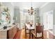 Stylish dining room offering hardwood floors, a unique light fixture, and a buffet at 3640 Ridgeway Ter, Suwanee, GA 30024