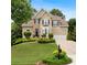 Charming two-story home featuring a stone facade, well-manicured lawn, and lush landscaping at 3640 Ridgeway Ter, Suwanee, GA 30024