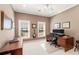 Well-lit office space with dual windows, desk, computer setup, and guitar, perfect for work and creativity at 3640 Ridgeway Ter, Suwanee, GA 30024