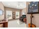 Well-lit office space with dual windows, desk, computer setup, and guitars, perfect for work and creativity at 3640 Ridgeway Ter, Suwanee, GA 30024