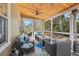Relaxing screened porch with comfortable seating, ceiling fans, and views of the lush surrounding landscape at 3640 Ridgeway Ter, Suwanee, GA 30024