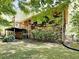 Backyard with deck, brick foundation, and lush landscaping; a serene outdoor retreat at 942 Ellison Ct, Austell, GA 30168