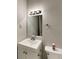 Bathroom features a clean vanity, a well-lit mirror, and modern fixtures at 942 Ellison Ct, Austell, GA 30168