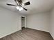 Empty bedroom with new vinyl plank flooring, ceiling fan, and natural light at 942 Ellison Ct, Austell, GA 30168