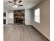Inviting living room features a brick fireplace and new vinyl plank flooring at 942 Ellison Ct, Austell, GA 30168