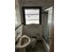 Bathroom with a window, tile walls, an older sink, toilet, and shower needing refurbishment at 1581 Se Woodland Se Cir, Atlanta, GA 30316