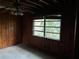 This interior shot shows a bedroom with paneled walls and a ceiling needing repair at 1581 Se Woodland Se Cir, Atlanta, GA 30316