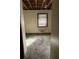 Unfinished bedroom with exposed ceiling, a window with blinds, and weathered green carpeting at 1581 Se Woodland Se Cir, Atlanta, GA 30316