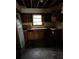 Interior shot of the kitchen with damaged wood cabinets and flooring at 1581 Se Woodland Se Cir, Atlanta, GA 30316