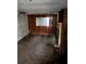Basement living room featuring wood paneled walls, a faux fireplace and peeling paint at 1581 Se Woodland Se Cir, Atlanta, GA 30316