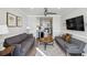 Open-concept living room and kitchen featuring hardwood flooring, a ceiling fan and neutral decor at 215 Piedmont Ne Ave # 2103, Atlanta, GA 30308