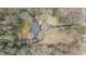 Aerial view showcasing the brick home, circular driveway, and detached garage nestled among mature trees at 3074 Cascade Sw Rd, Atlanta, GA 30311