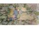Aerial view showcases an estate with a circular driveway, lush greenery, a brick home, and a detached garage at 3074 Cascade Sw Rd, Atlanta, GA 30311