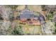 Aerial view of a brick home with a patio, screened-in porch, and detached garage surrounded by trees at 3074 Cascade Sw Rd, Atlanta, GA 30311