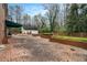 Expansive brick patio with garden beds, creating a tranquil outdoor space for relaxation and entertaining at 3074 Cascade Sw Rd, Atlanta, GA 30311